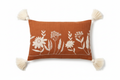 Terracotta floral embroidered lumbar cushion cover with corner tassels — flat lay