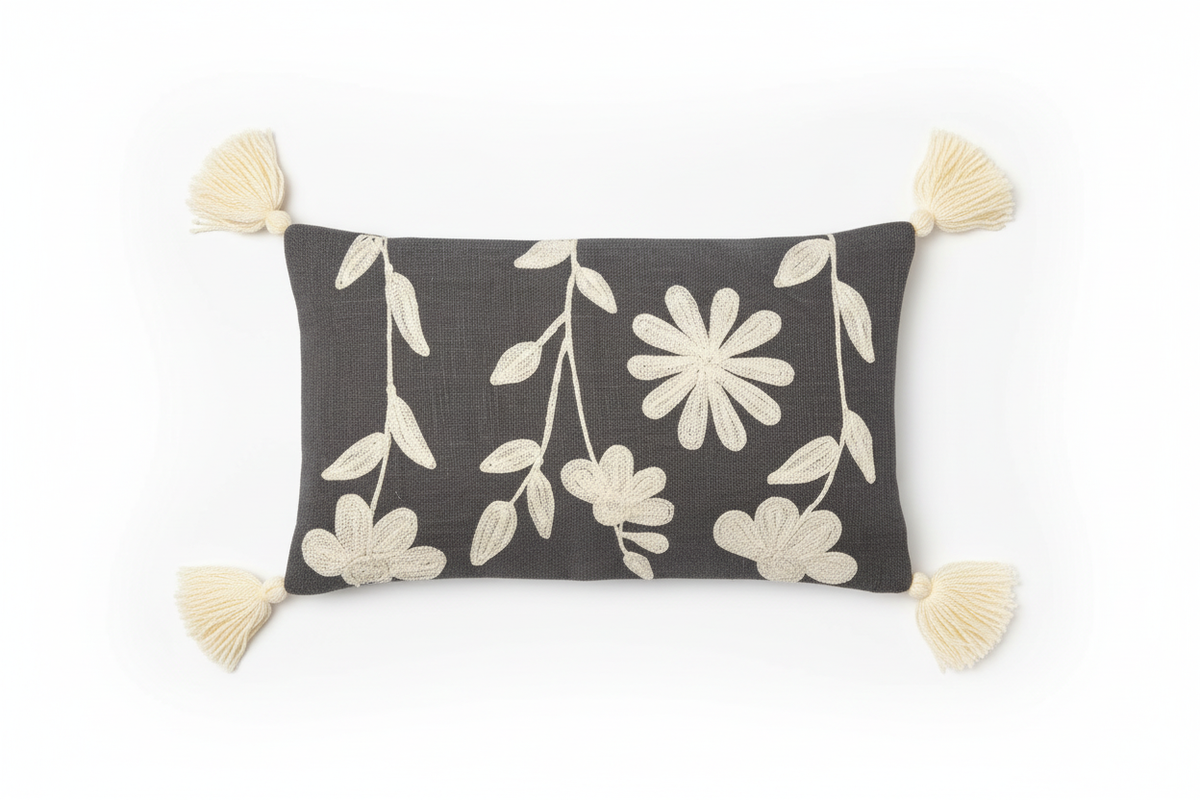 Charcoal floral appliqué lumbar cushion cover with corner tassels — flat lay