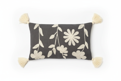 Charcoal floral appliqué lumbar cushion cover with corner tassels — flat lay