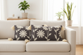Two charcoal floral lumbar cushion covers styled on a Scandinavian linen sofa — living room